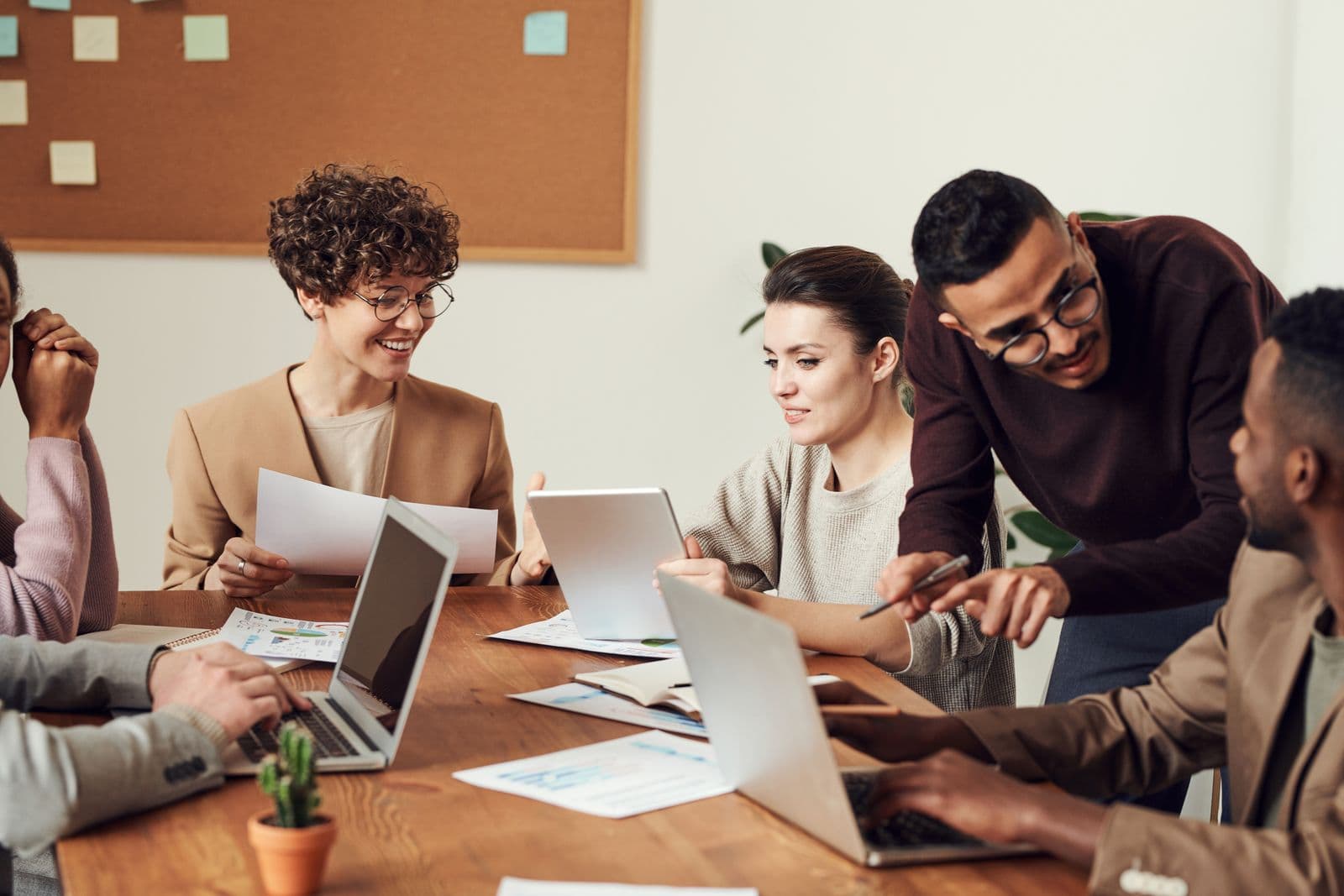 People collaborating on laptops — a logged-in portal, not a brochure
