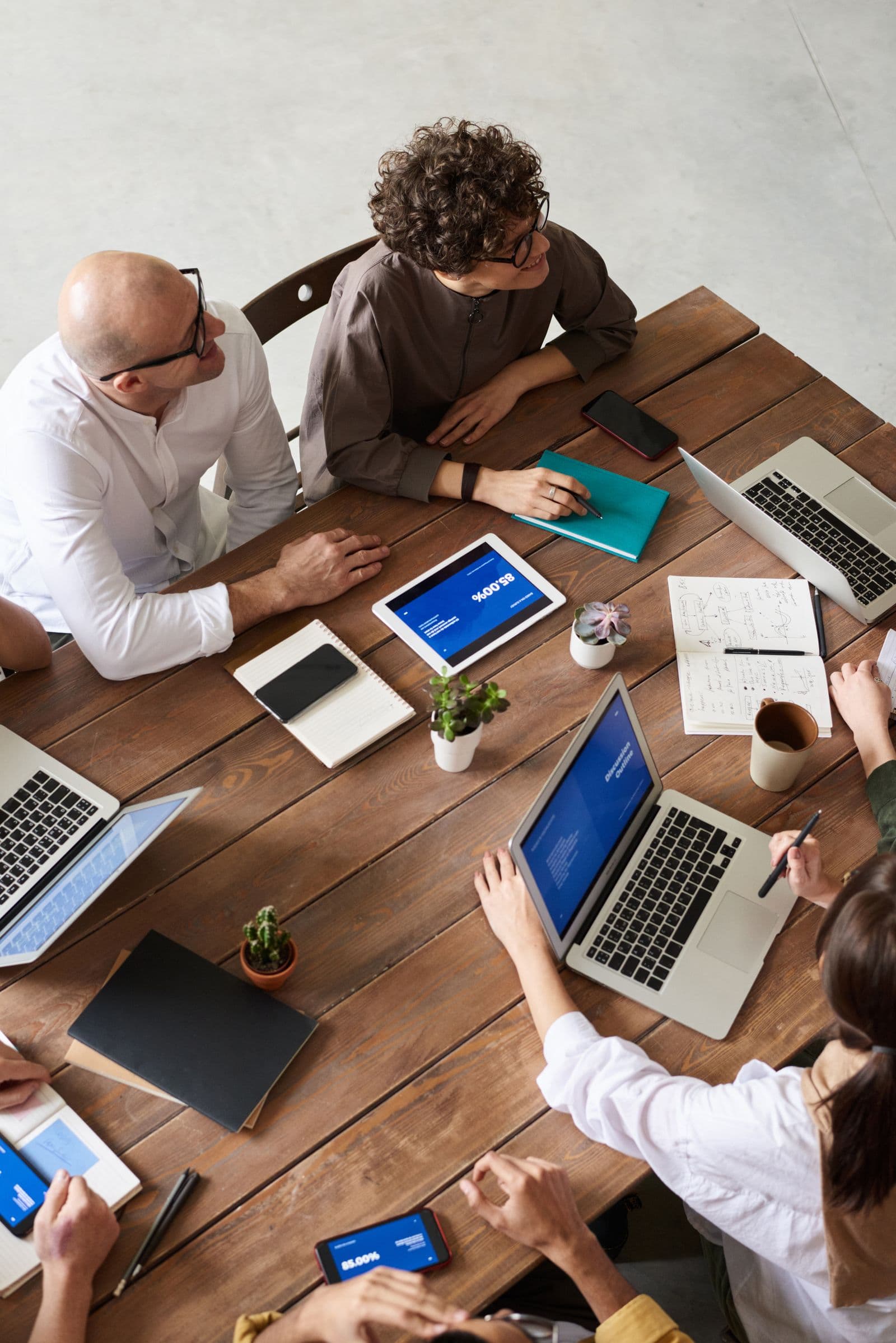 Software team collaborating around laptops in an office