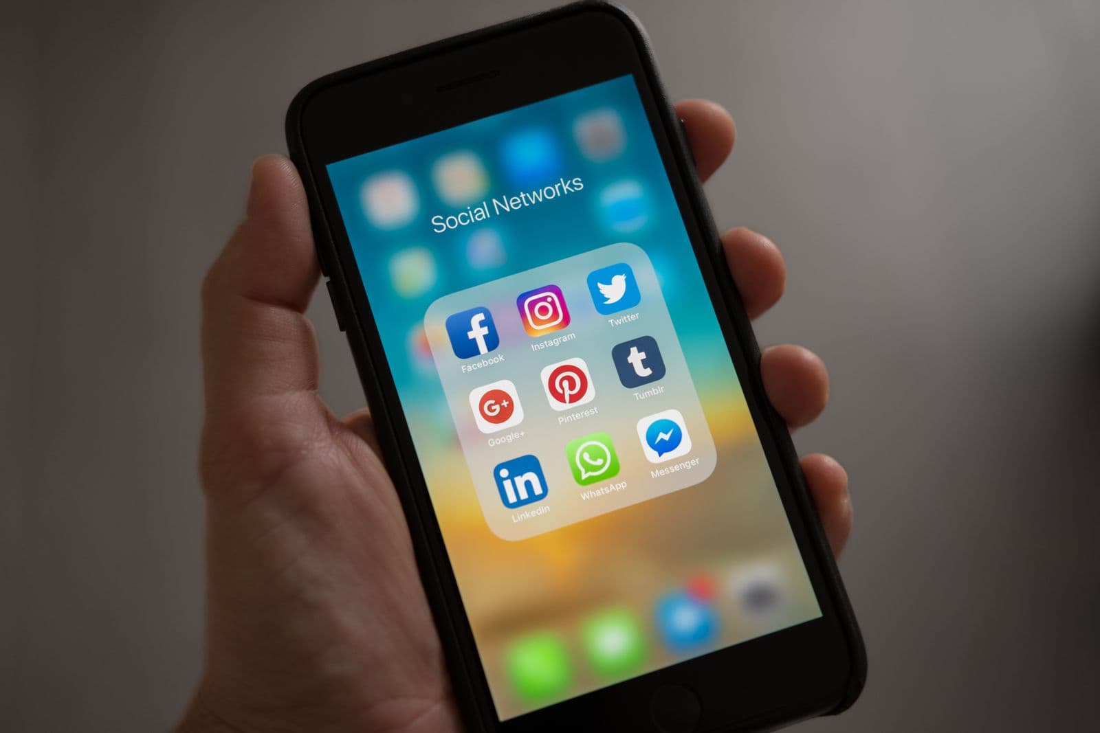 Hands holding a phone while reviewing a custom mobile app