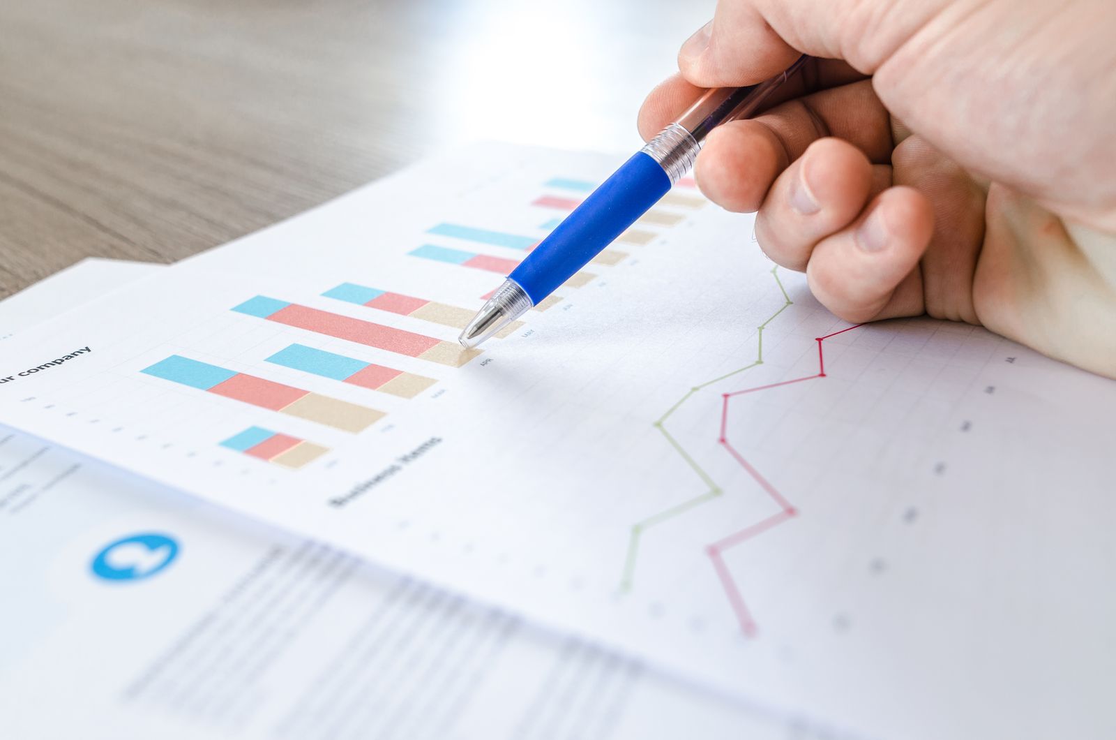 Spreadsheets and notes on a desk — the brief before custom business software